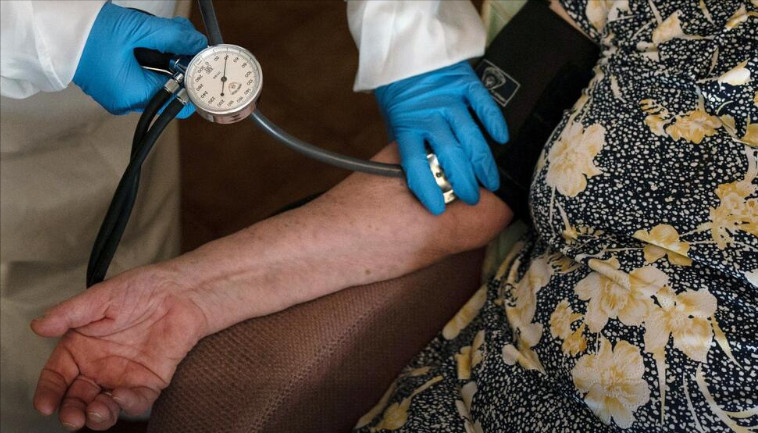 old woman having blood pressure taken