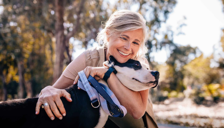 old lady hugging dog