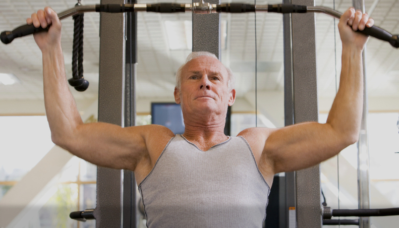 old man using exercise machine